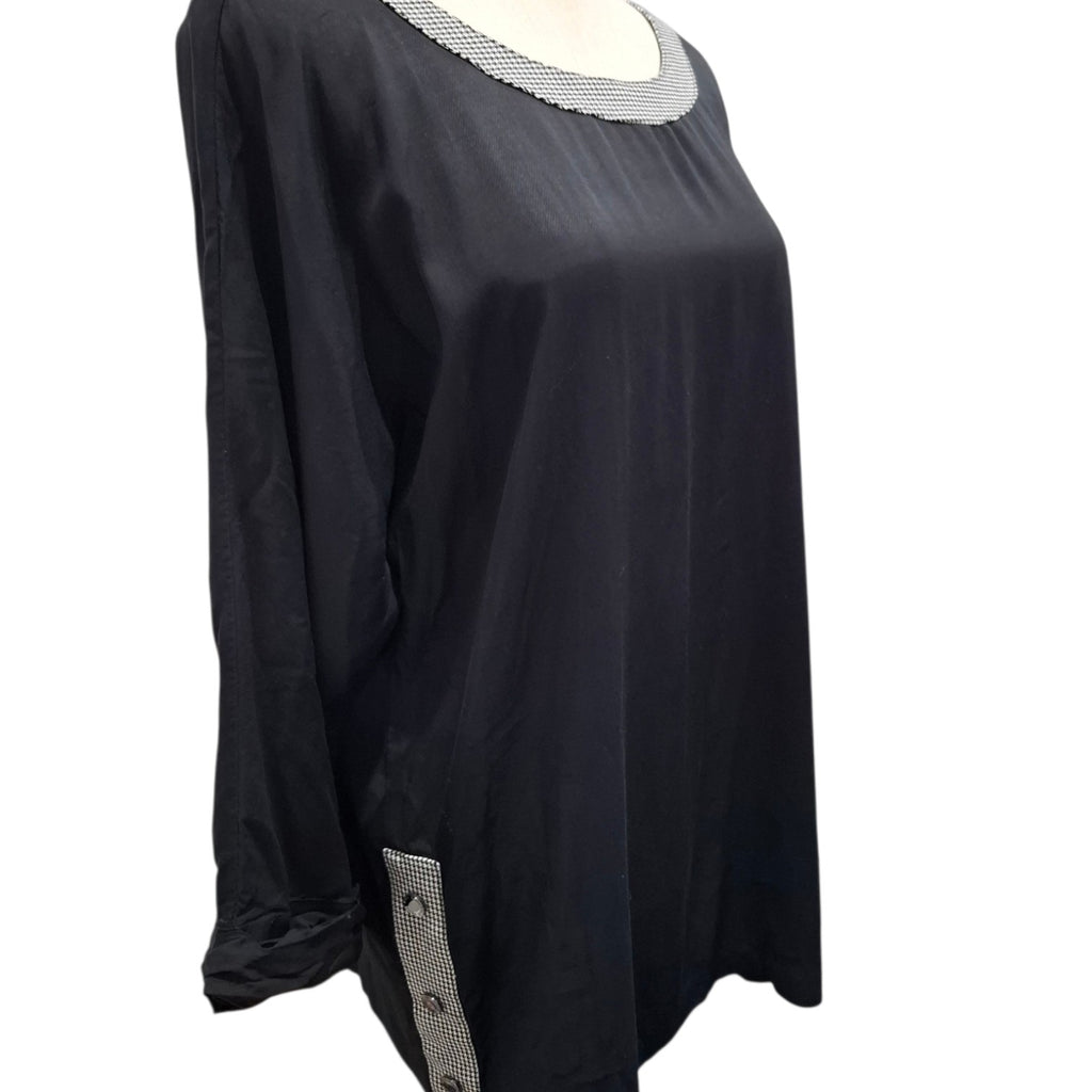 A black long-sleeve tunic top with a textured silver-gray beaded neckline and a matching beaded side detail near the hem, displayed on a mannequin against a white background.