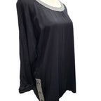 A black long-sleeve tunic top with a textured silver-gray beaded neckline and a matching beaded side detail near the hem, displayed on a mannequin against a white background.
