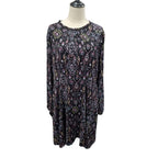 A long-sleeve tunic dress with an intricate multicolor paisley and floral pattern on a black base, displayed on a mannequin torso against a white background.