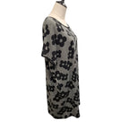 A short-sleeve knit top with a black and white floral pattern, displayed on a mannequin torso against a plain white background.