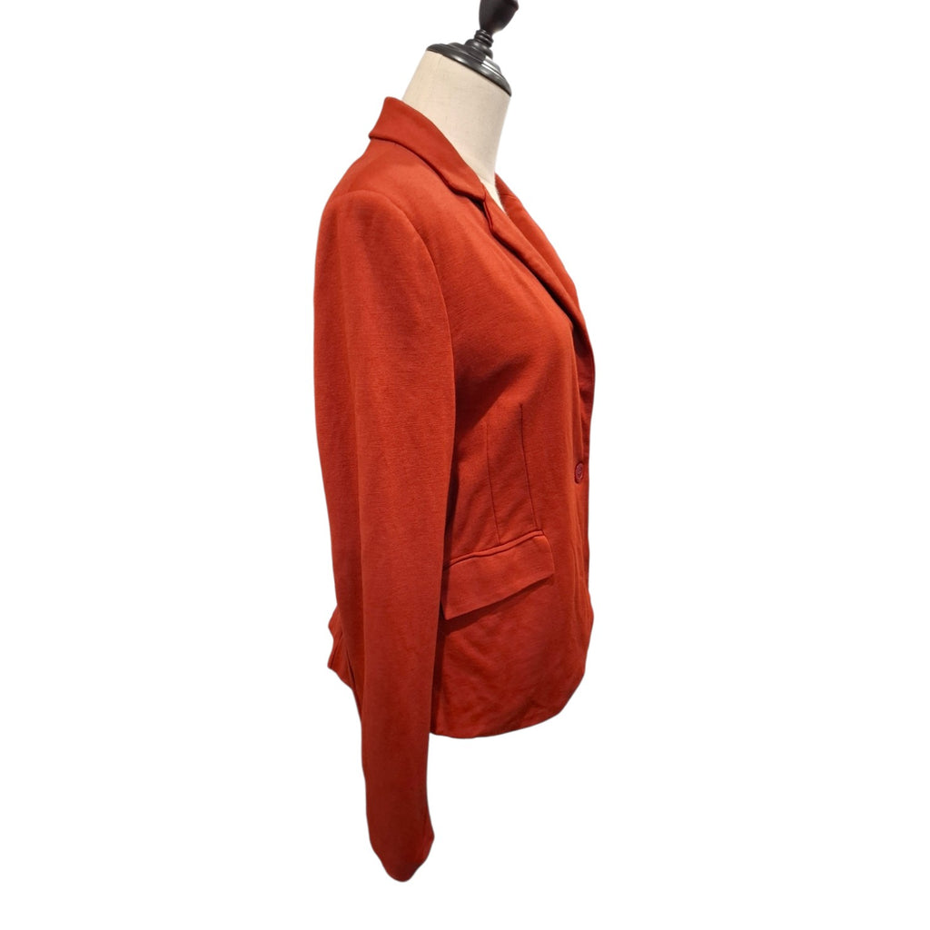 A rust-orange cropped blazer displayed on a cream dress form mannequin against a plain white background.