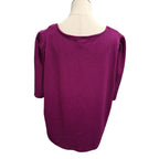 A magenta ribbed knit top with three-quarter sleeves and a wide boat neckline, displayed on a cream dress form mannequin against a white background.