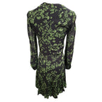 A long-sleeve midi dress with a green botanical and bird pattern on a black background, shown from the back against a plain white background.