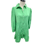 A bright green long-sleeve button-up shirt dress displayed on a mannequin torso against a plain white background.