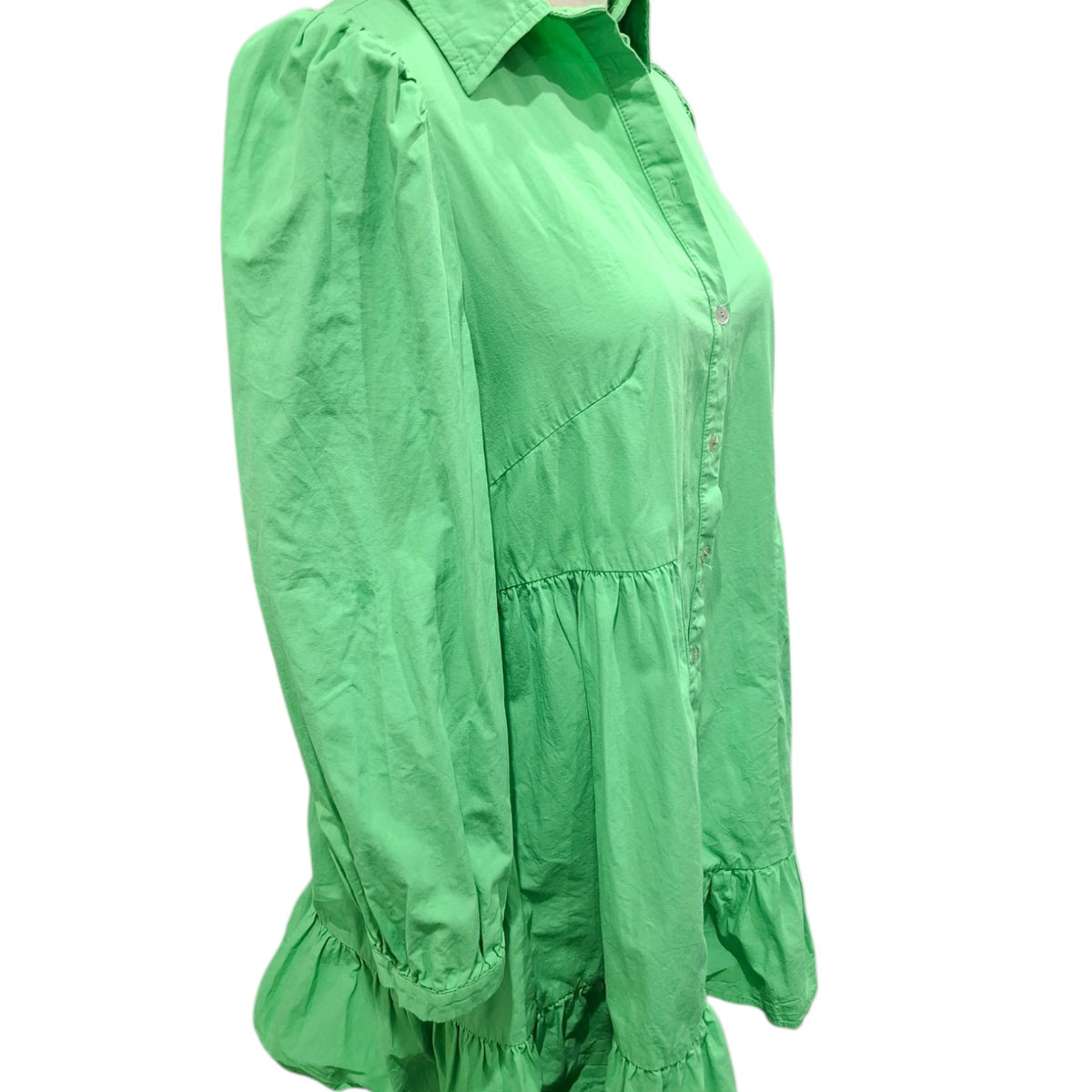 A bright green long-sleeve button-up blouse with a pointed collar, gathered waist seam, and ruffled cuffs, shown on a plain white background.