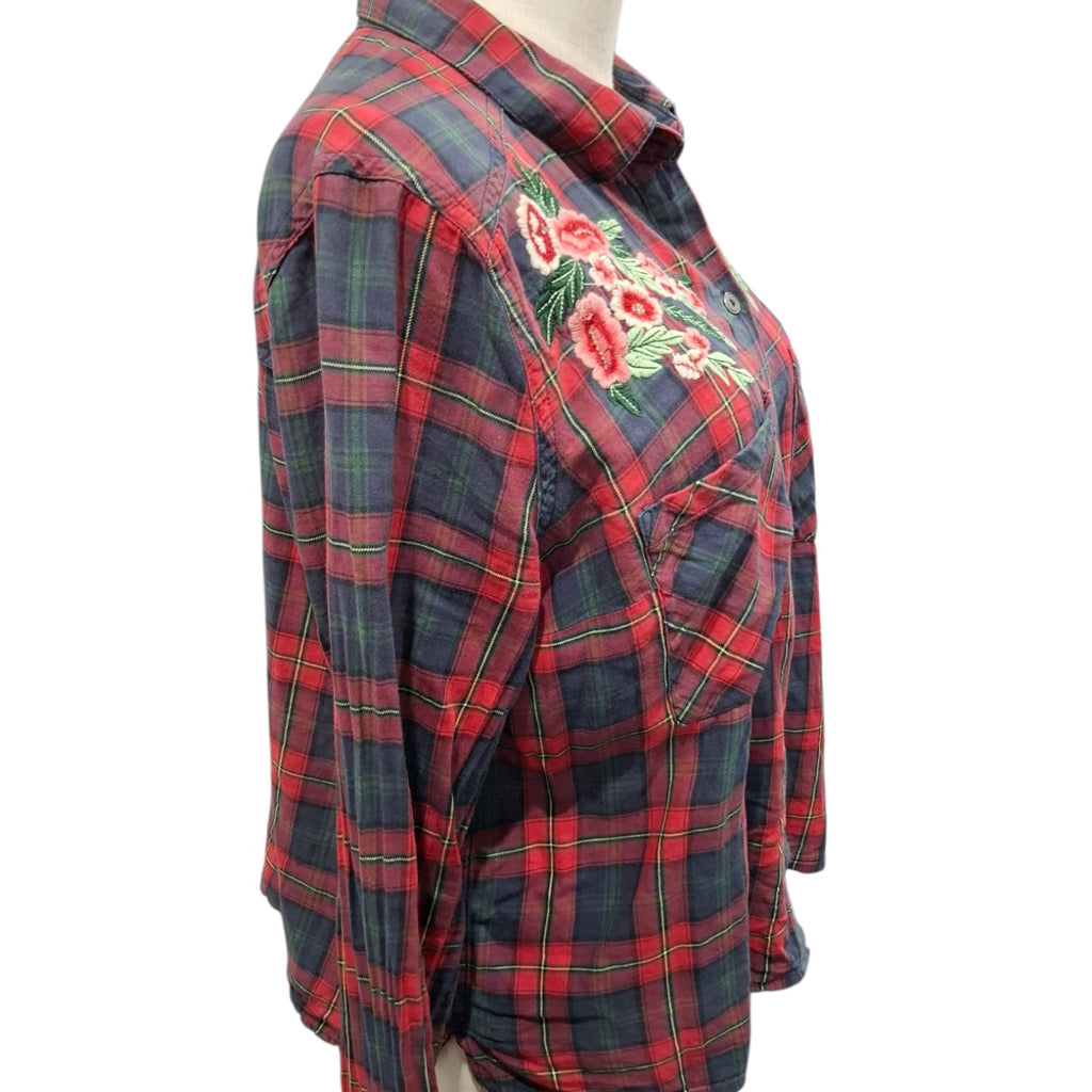 A red and navy plaid button-up shirt with a floral embroidered design on the chest, displayed on a mannequin torso against a white background.