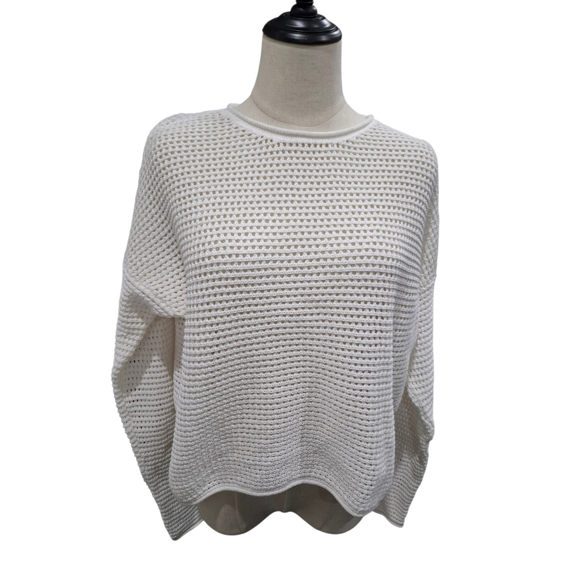 A cream-colored open-knit sweater displayed on a mannequin torso against a plain white background.