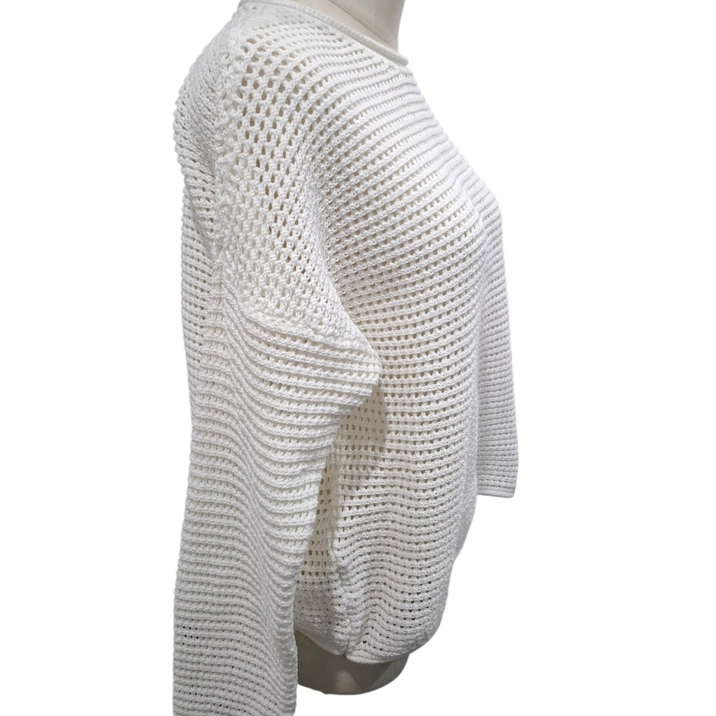 A white open-knit cropped sweater displayed on a mannequin torso against a plain white background.