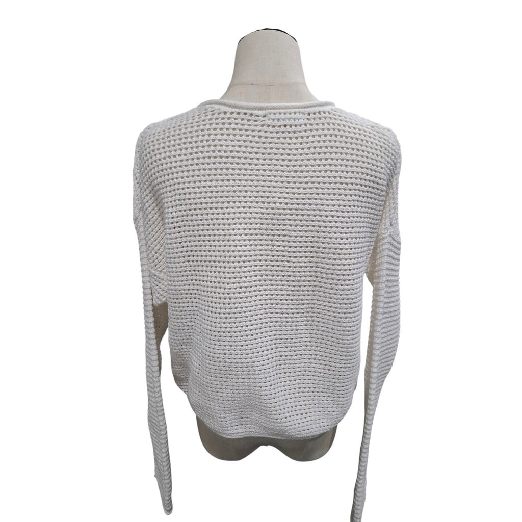 A cream-colored open-knit long-sleeve sweater displayed on a mannequin torso against a plain white background.