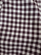 A close-up of a black and white gingham checkered fabric pattern.