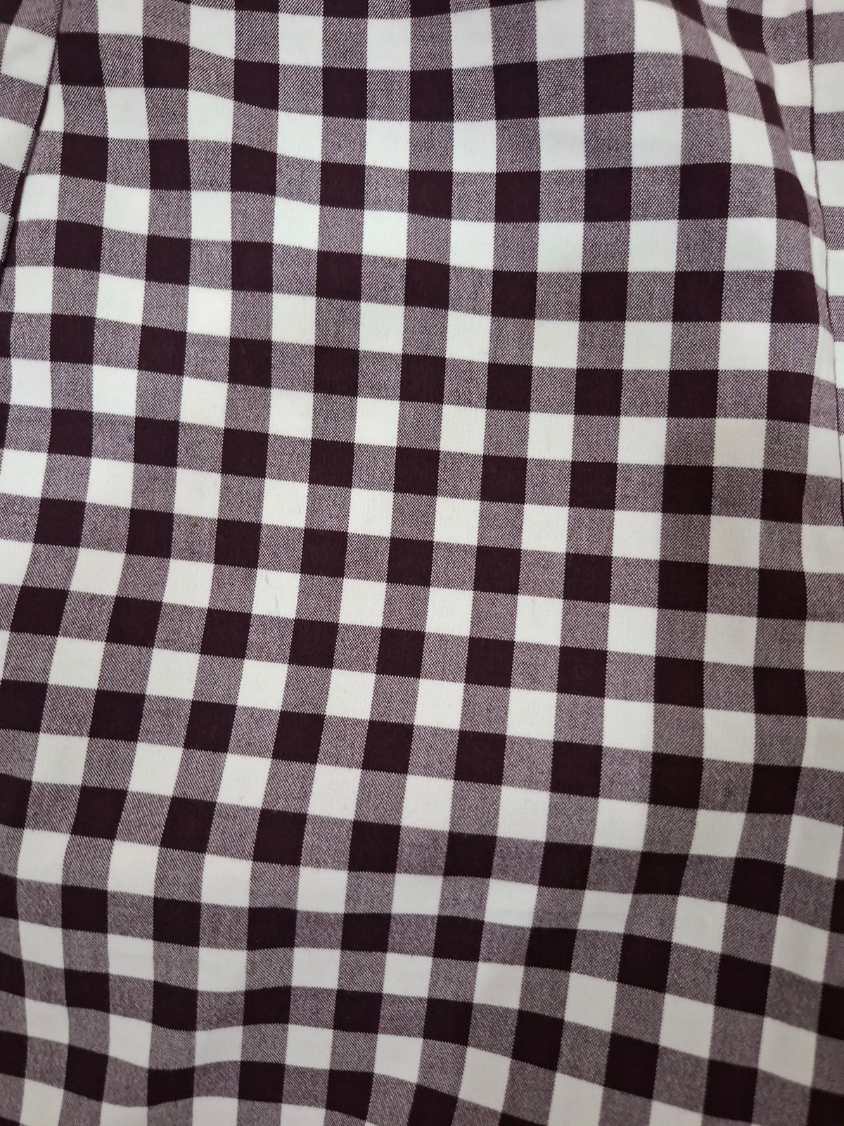 A close-up of a black and white gingham checkered fabric pattern.