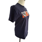 A navy blue short-sleeve graphic t-shirt displayed on a mannequin torso against a white background. The shirt features a large collegiate-style 'FSU' logo printed across the chest in orange, white, and black.
