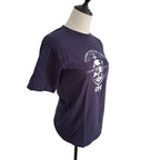 A dark purple short-sleeve t-shirt displayed on a mannequin torso against a white background. The shirt features a white graphic print on the front with the text 'CHURCHILL & LONE STAR CAMPS' and 'CFC'.