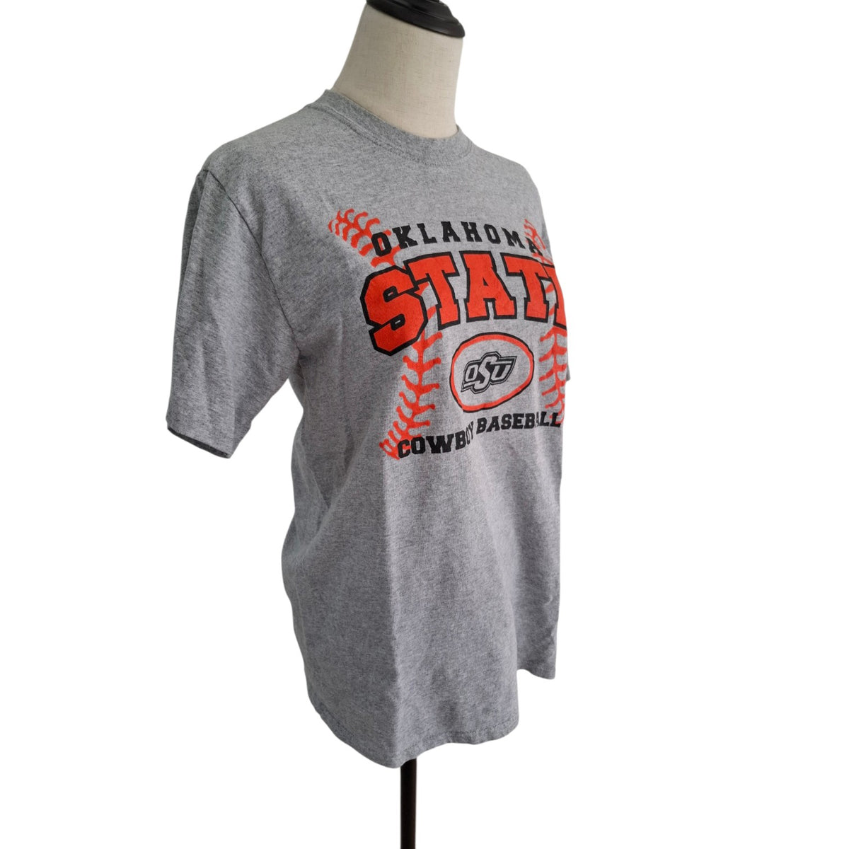 A heather gray short-sleeve t-shirt displayed on a mannequin torso, featuring a large 'Oklahoma State Cowboys Baseball' graphic in red and black on the front.