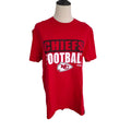 A red short-sleeve Kansas City Chiefs t-shirt displayed on a mannequin torso against a plain white background. The shirt features 'CHIEFS FOOTBALL' printed on the front in black and white, along with the Kansas City Chiefs logo.