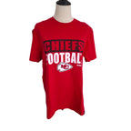 A red short-sleeve Kansas City Chiefs t-shirt displayed on a mannequin torso against a plain white background. The shirt features 'CHIEFS FOOTBALL' printed on the front in black and white, along with the Kansas City Chiefs logo.