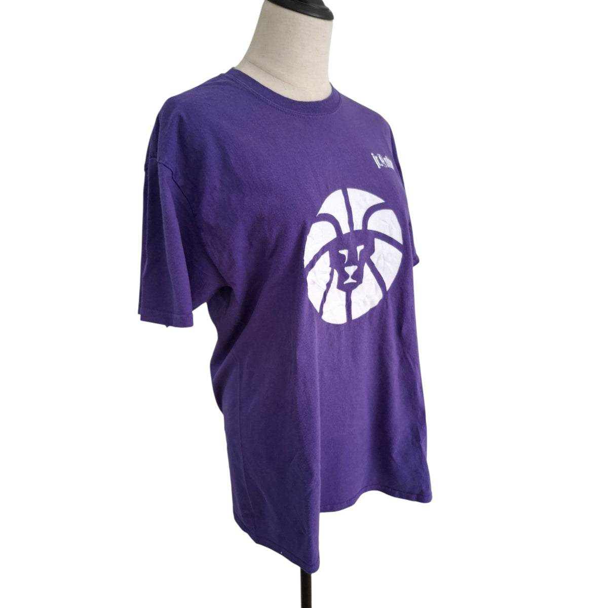 A purple short-sleeve t-shirt displayed on a mannequin torso against a white background. The shirt features a large white basketball graphic with a purple 'I' logo in the center and a small white script logo on the upper right chest.