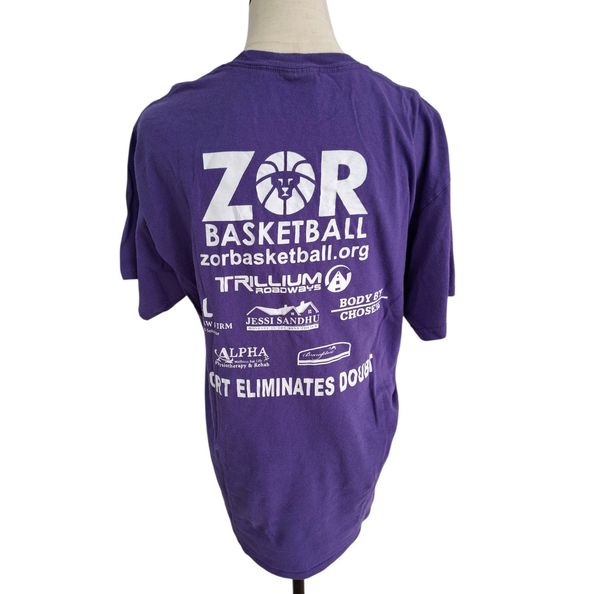 A purple short-sleeve t-shirt displayed on a mannequin torso, showing the back side with white printed graphics and text for 'ZOR Basketball' and sponsor logos.