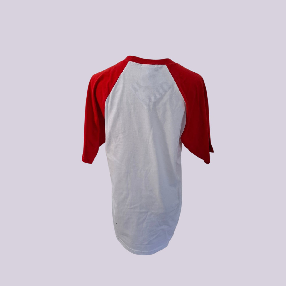 A red and white raglan baseball t-shirt shown from the back, featuring a white body and red three-quarter sleeves, set against a solid light purple background.