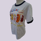 A white ringer t-shirt with black trim on the collar and cuffs, featuring a colorful cartoon graphic of hot dogs and candy canes with the words 'Hot Dogs to the Moon!' and 'Safreshments!' on a light gray background.