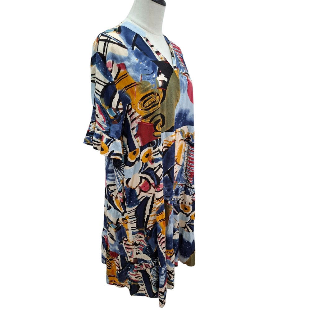A short-sleeve V-neck tunic dress with an abstract multicolor print, displayed on a headless mannequin torso against a plain white background.