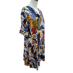 A short-sleeve V-neck tunic dress with an abstract multicolor print, displayed on a headless mannequin torso against a plain white background.