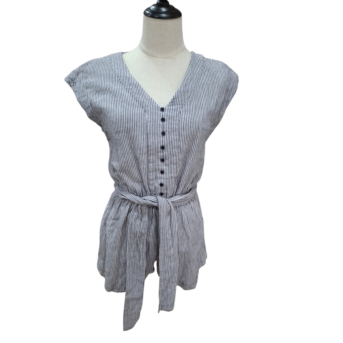 A women's short-sleeve belted top with a V-neck and front button placket, shown on a dress form mannequin against a white background.