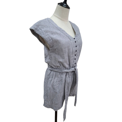 A gray and white vertically striped short romper with a tie waist belt, displayed on a cream mannequin torso against a white background.