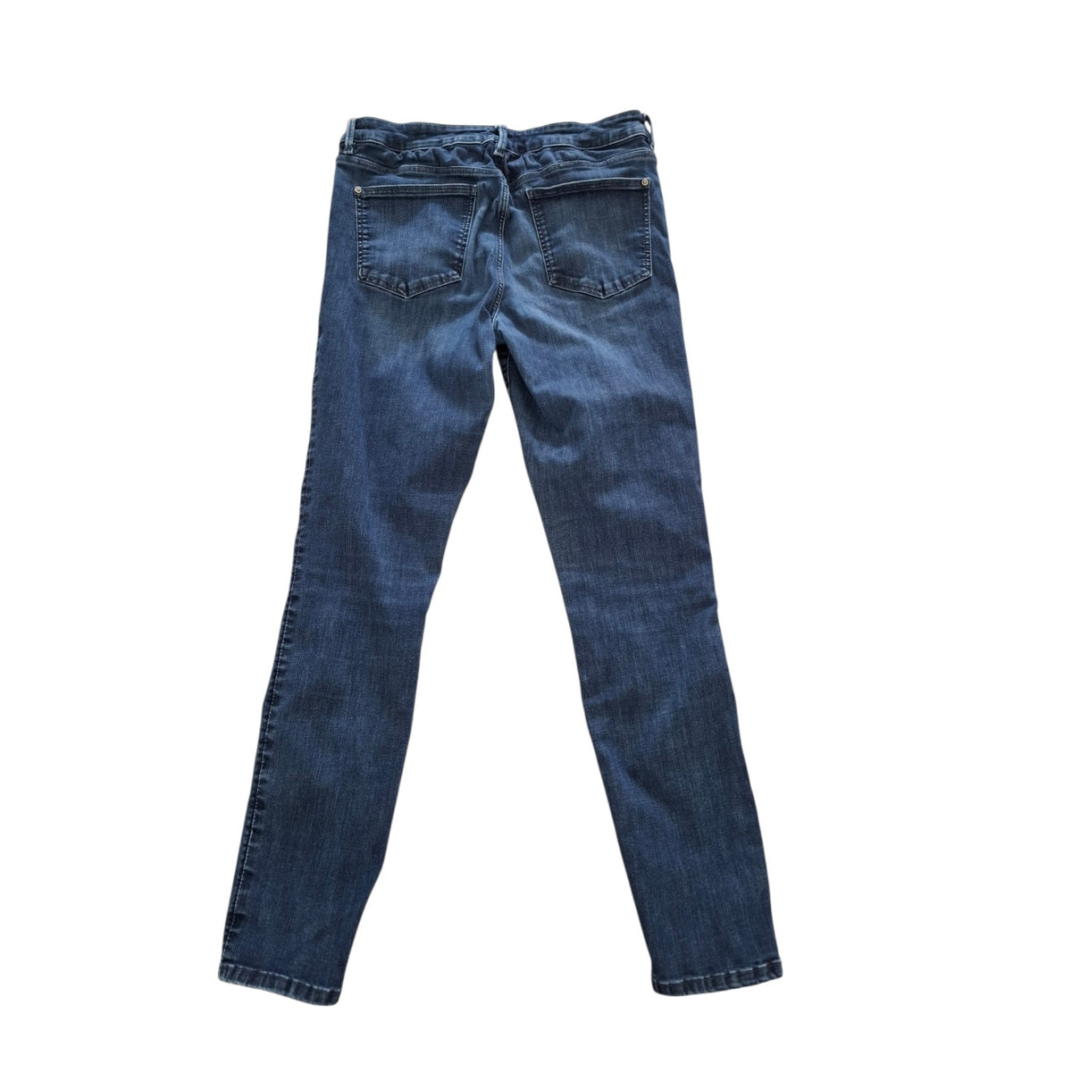 A pair of dark blue denim jeans shown from the back, laid flat against a solid white background.