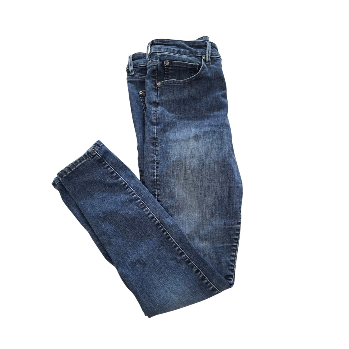 A pair of folded blue denim jeans with a faded wash, displayed on a solid white background.