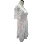 White short-sleeve eyelet lace top displayed on a cream dress form mannequin against a plain white background.