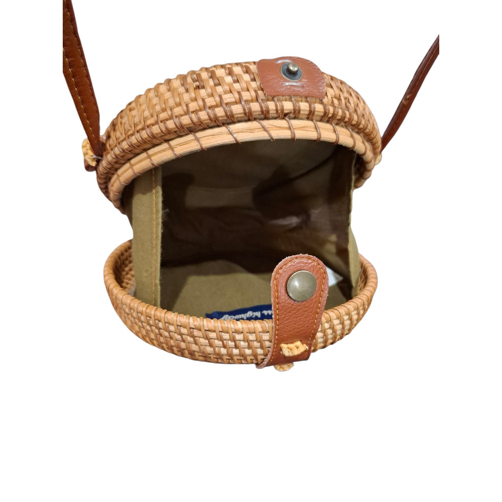 A woven straw pouch with brown leather strap and snap closure, shown open against a plain white background.