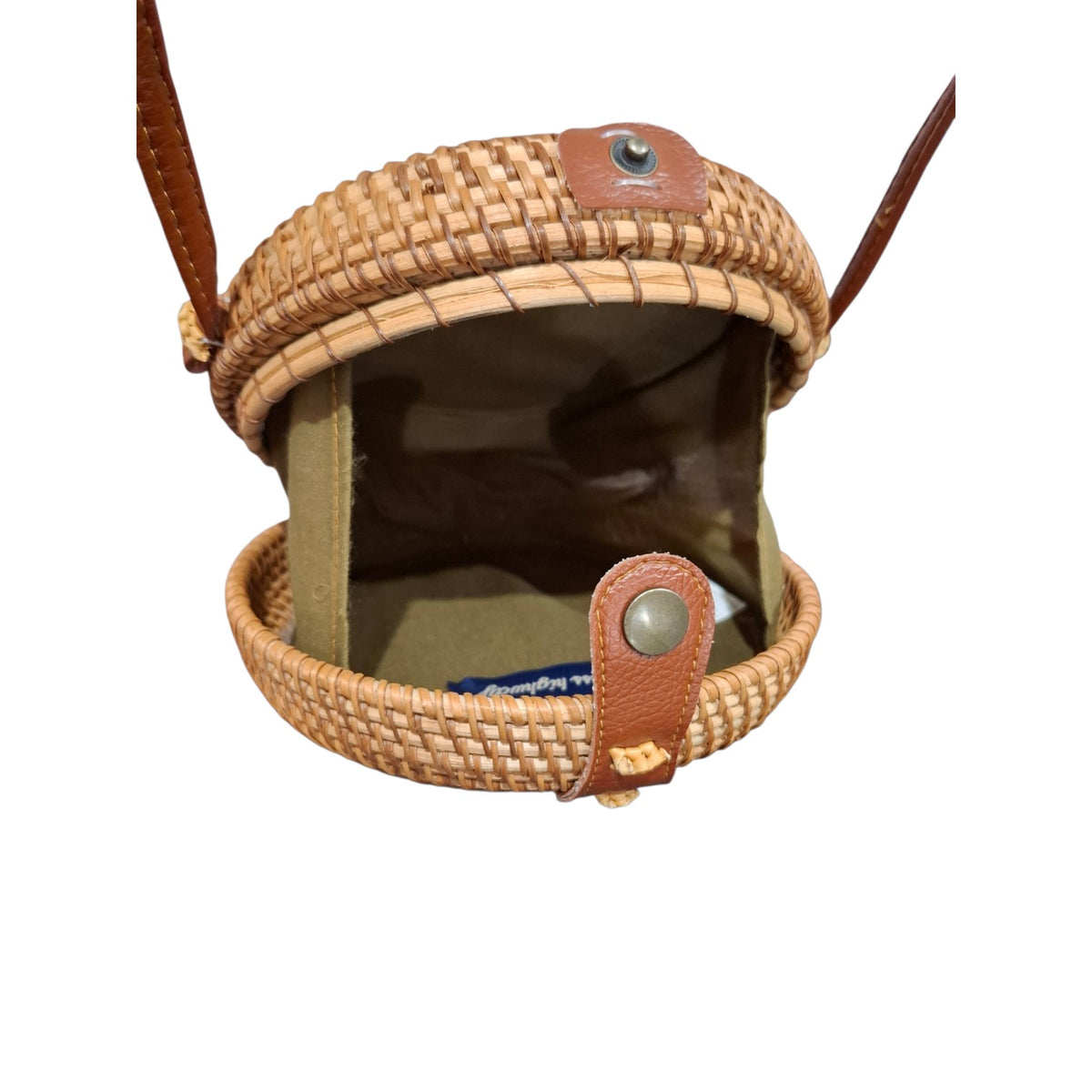 A woven straw pouch with brown leather strap and snap closure, shown open against a plain white background.