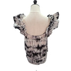 A women's top displayed on a dress form mannequin, showing the back view. The top features a black and white tie-dye pattern with dramatic ruffled shoulder straps and a scoop neckline.