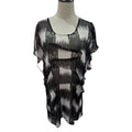 A sheer black and white abstract-patterned blouse displayed on a mannequin torso against a plain white background.