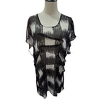 A sheer black and white abstract-patterned blouse displayed on a mannequin torso against a plain white background.