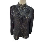 A black lace long-sleeve blouse with a high mock neck and ruffled chest detail, displayed on a mannequin torso against a white background.