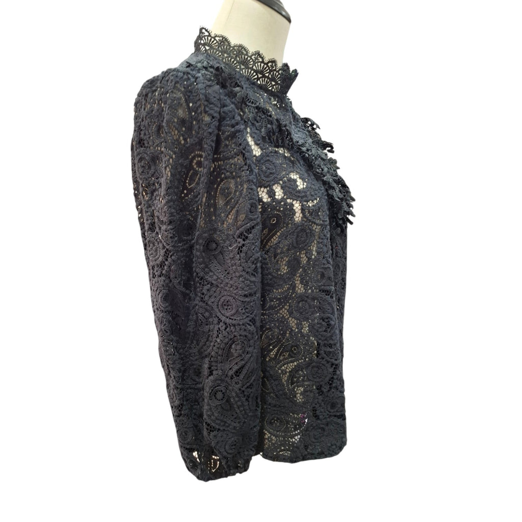 A black lace jacket with a high lace collar and ruffled trim, displayed on a mannequin torso against a white background.