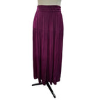 A pleated, tiered maxi skirt in deep plum purple, displayed on a mannequin torso with a black stand against a plain white background.
