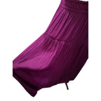 A close-up of a pleated skirt in a rich magenta-purple color, showing the fabric texture and pleated details against a plain white background.