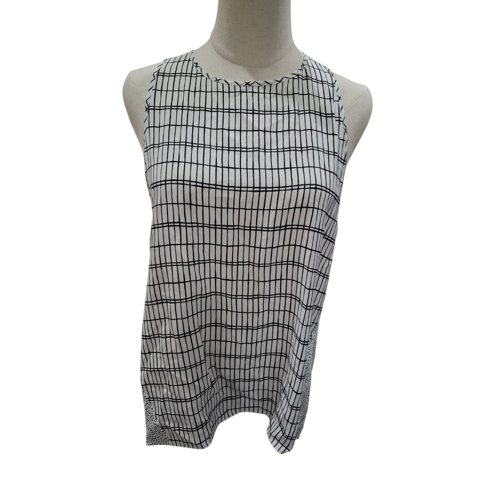 A sleeveless white top with a black grid pattern, displayed on a mannequin torso against a plain white background.