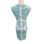 A mint green sleeveless bodycon dress shown from the back on a mannequin, featuring white contrast straps forming a geometric pattern.