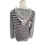 A women's long-sleeve hoodie top displayed on a mannequin torso, featuring a black and white wavy stripe pattern across the body and sleeves, with solid heather gray sleeves and hood.