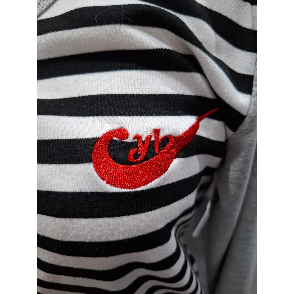 Close-up of a black and white horizontally striped garment with a red embroidered logo on the chest.