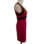 A sleeveless color-block dress displayed on a mannequin, featuring a deep magenta skirt, a brown upper section, and black trim details.
