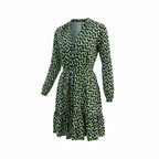 A long-sleeve wrap-style dress with a V-neckline and self-tie waist, featuring an all-over abstract leaf-like pattern in green, black, and light blue on a white base, shown against a plain white background.
